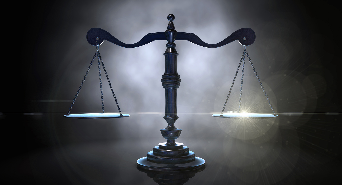 Scales of justice on dark background